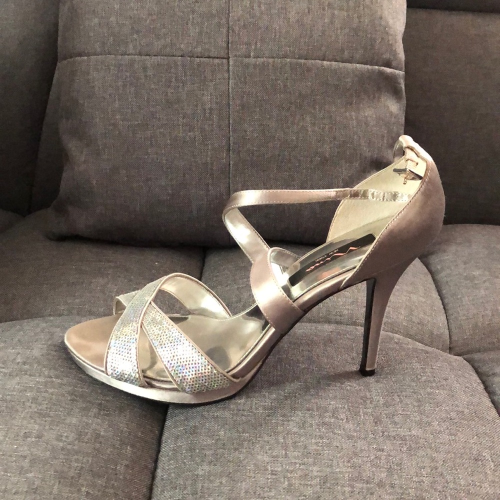 I am selling a pair of silver heels by Nina.